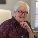Becky Berry at her desk, smiling.