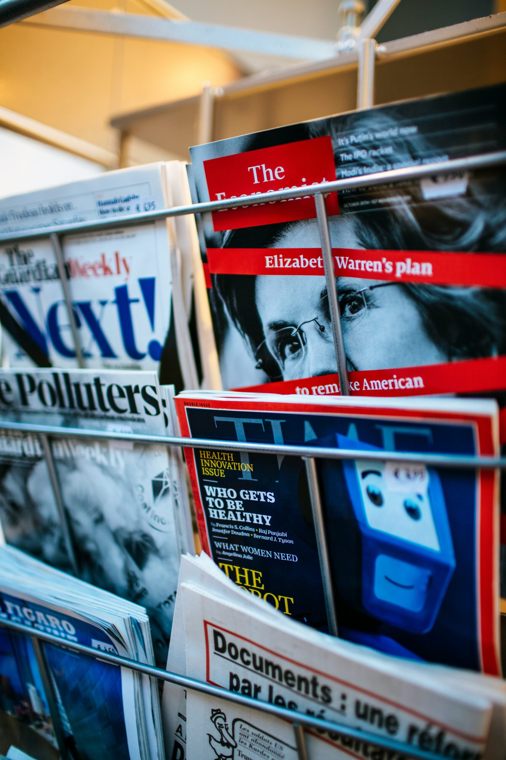 photo of magazine rack displaying The Economist magazine with Elizabeth Warren on the cover.